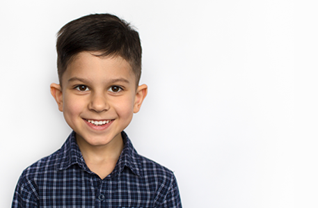 Latin American Boy Smiling Against White Background