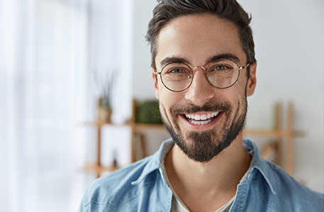 Man with Glasses Smiling with White Teeth