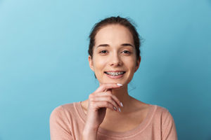 woman with braces smiling after general dentistry in jersey village tx from the jersey village tx general dentist