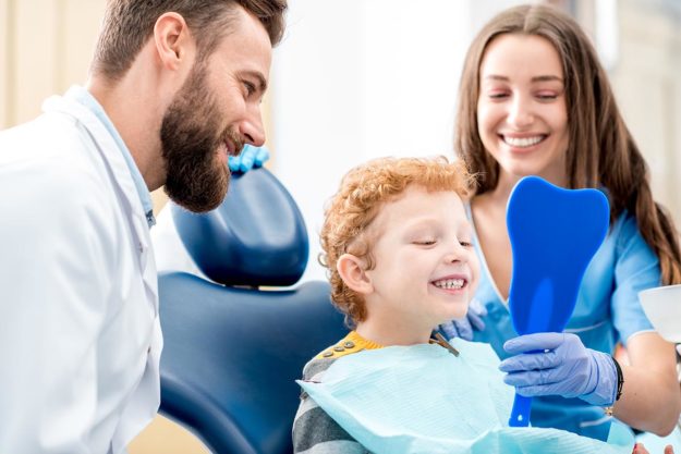 mom dentist and child celebrating National Children's Dental Health Month