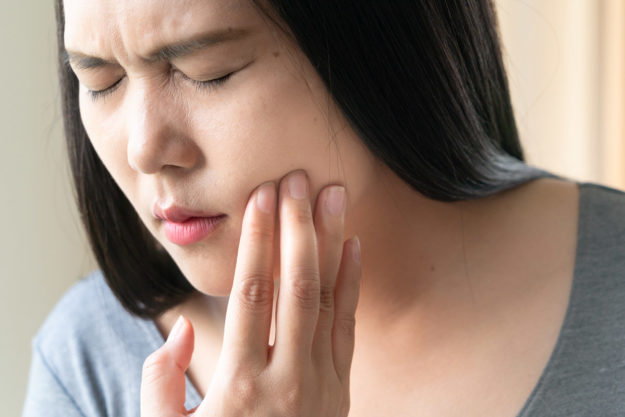 common dental problems (4) woman suffering from common dental problems