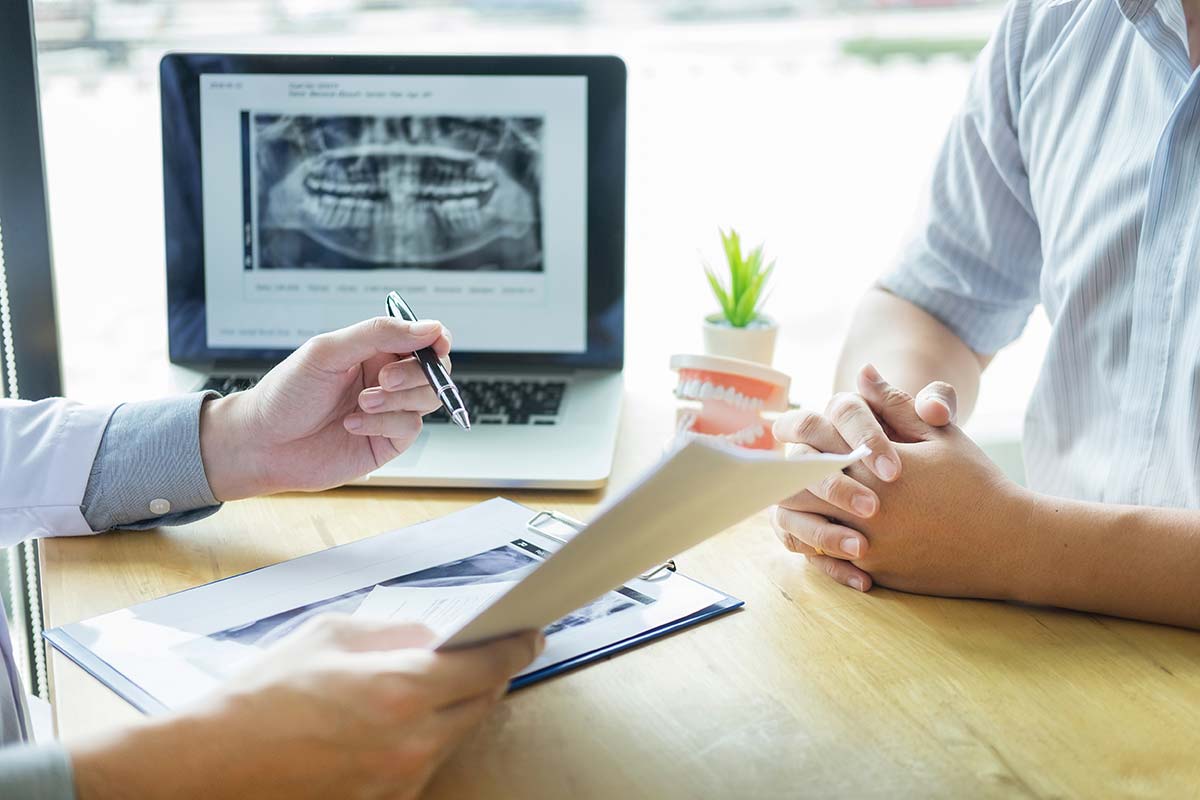 people discuss a dental emergency with xrays