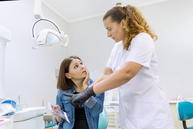 What-You-Need-to-Know-About-Treating-a-Chipped-Tooth woman suffering from a chipped tooth