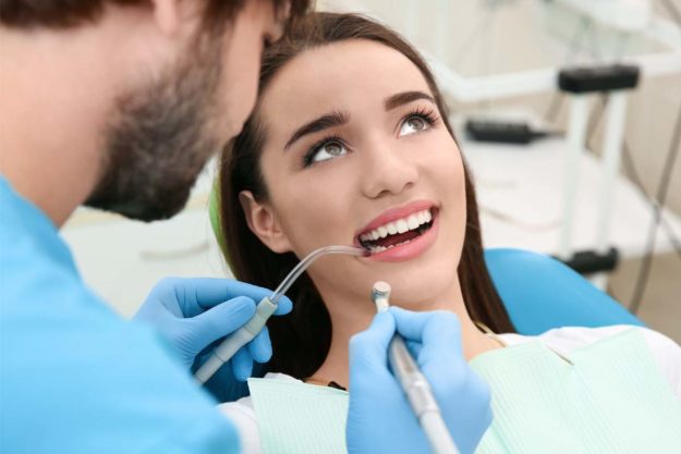 dental-health-services young woman visiting her dentist for dental health services