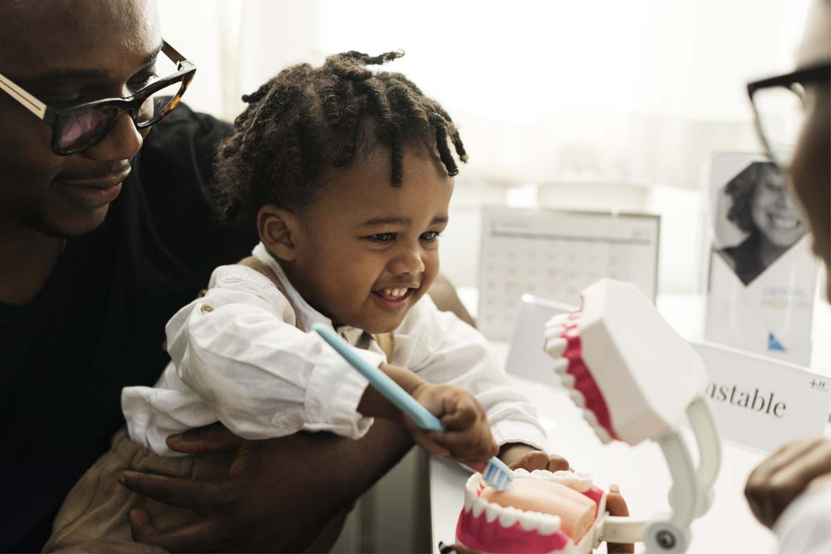 parent asking the dentist when should a child go to the dentist