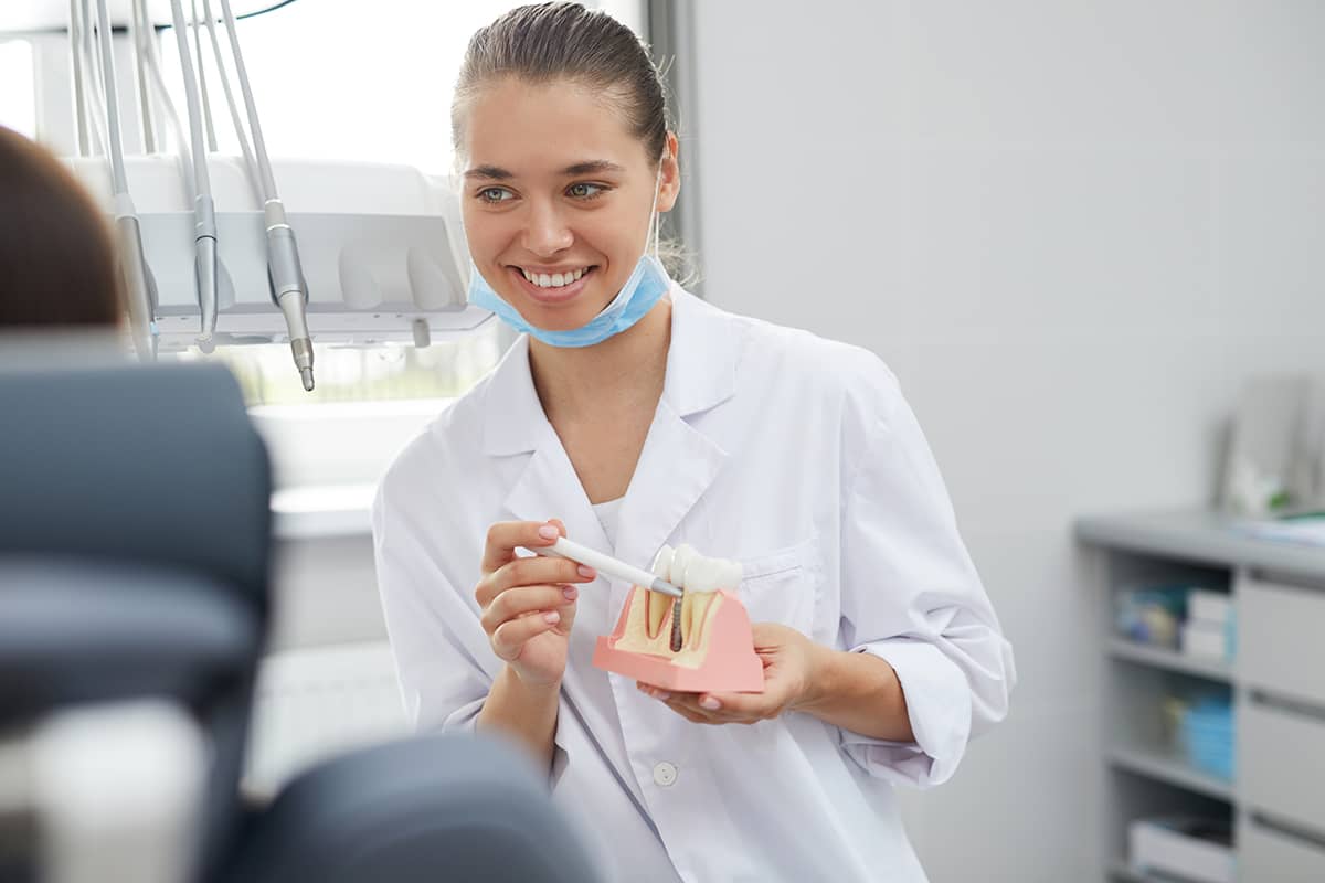 dentist holding dental implants