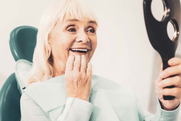 dentures (2) older woman examining her dentures