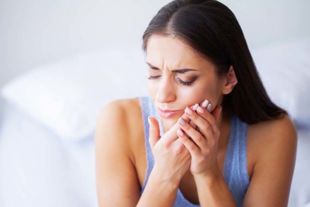 woman experiencing tooth pain