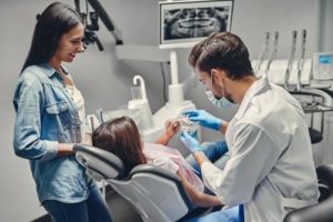 mom with daughter learning about family dentistry