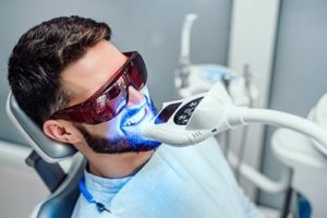 man getting teeth whitening services