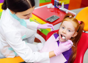 girl learning about pediatric dentistry 